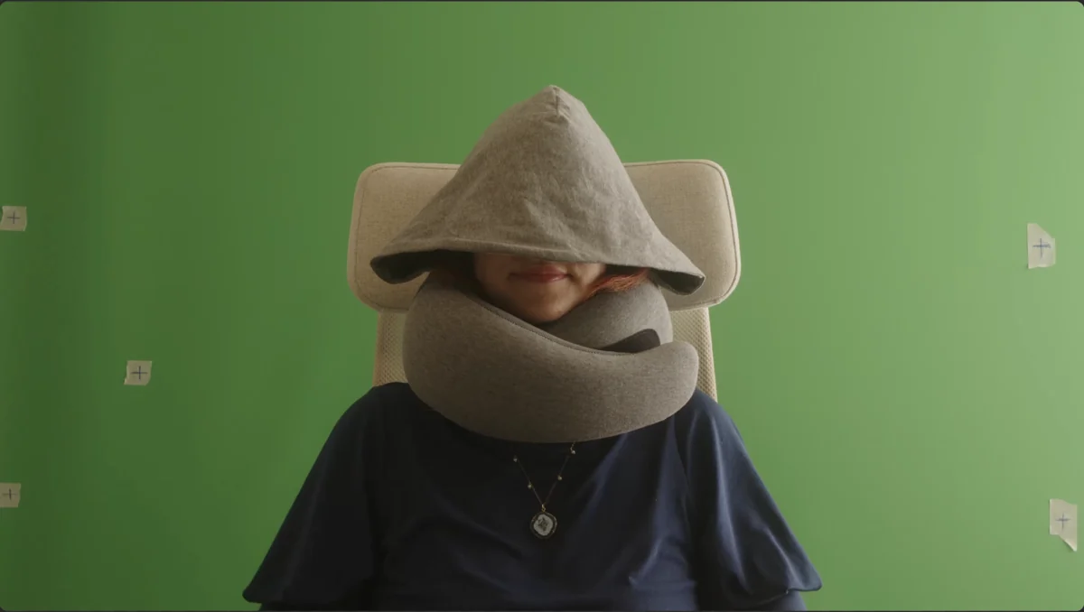 Original filmed actress and travel pillow against green screen